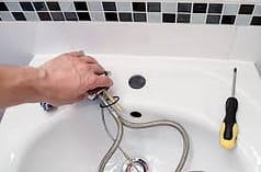 plumber fixing sink